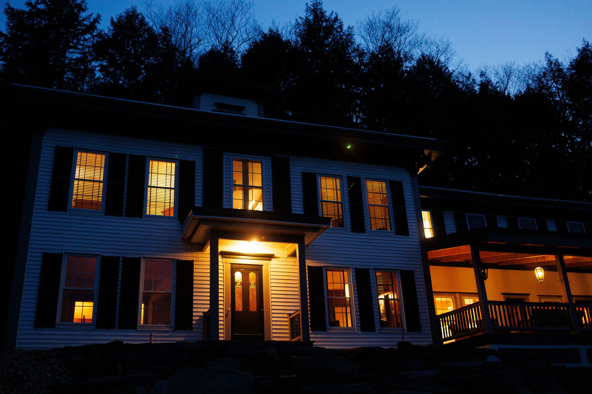 The Cobble House lit up at night under a deep blue sky