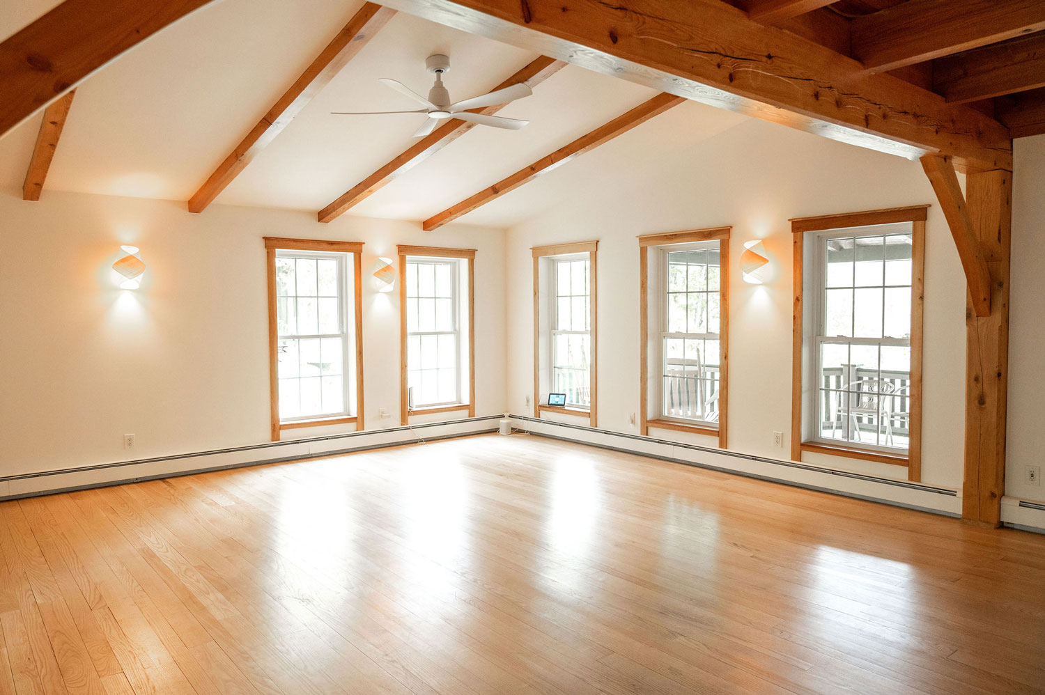 A corner of the music room showing two walls lined with windows