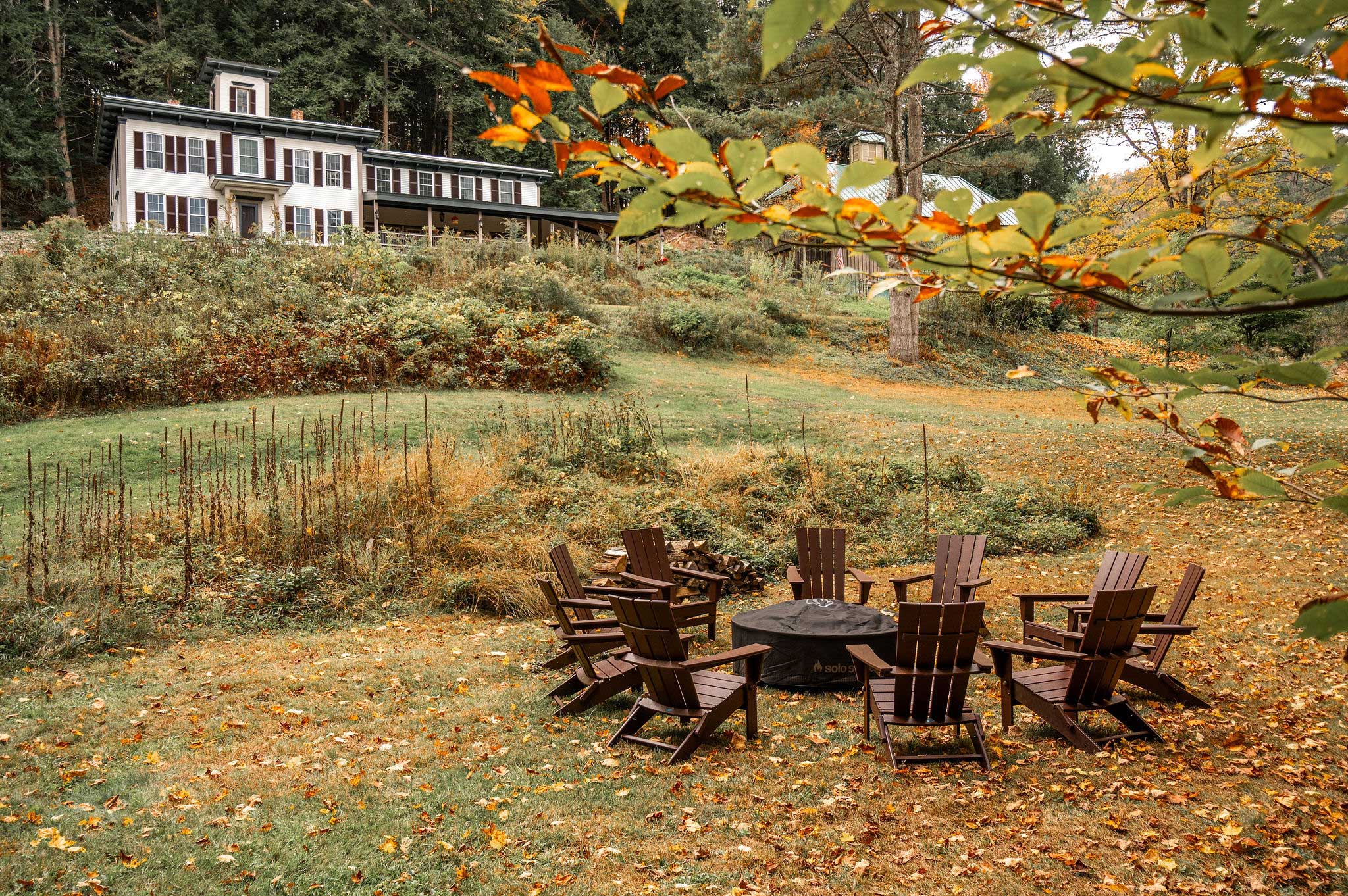 a fire pit on the grounds of the Cobble House surrounded by comfortable chairs