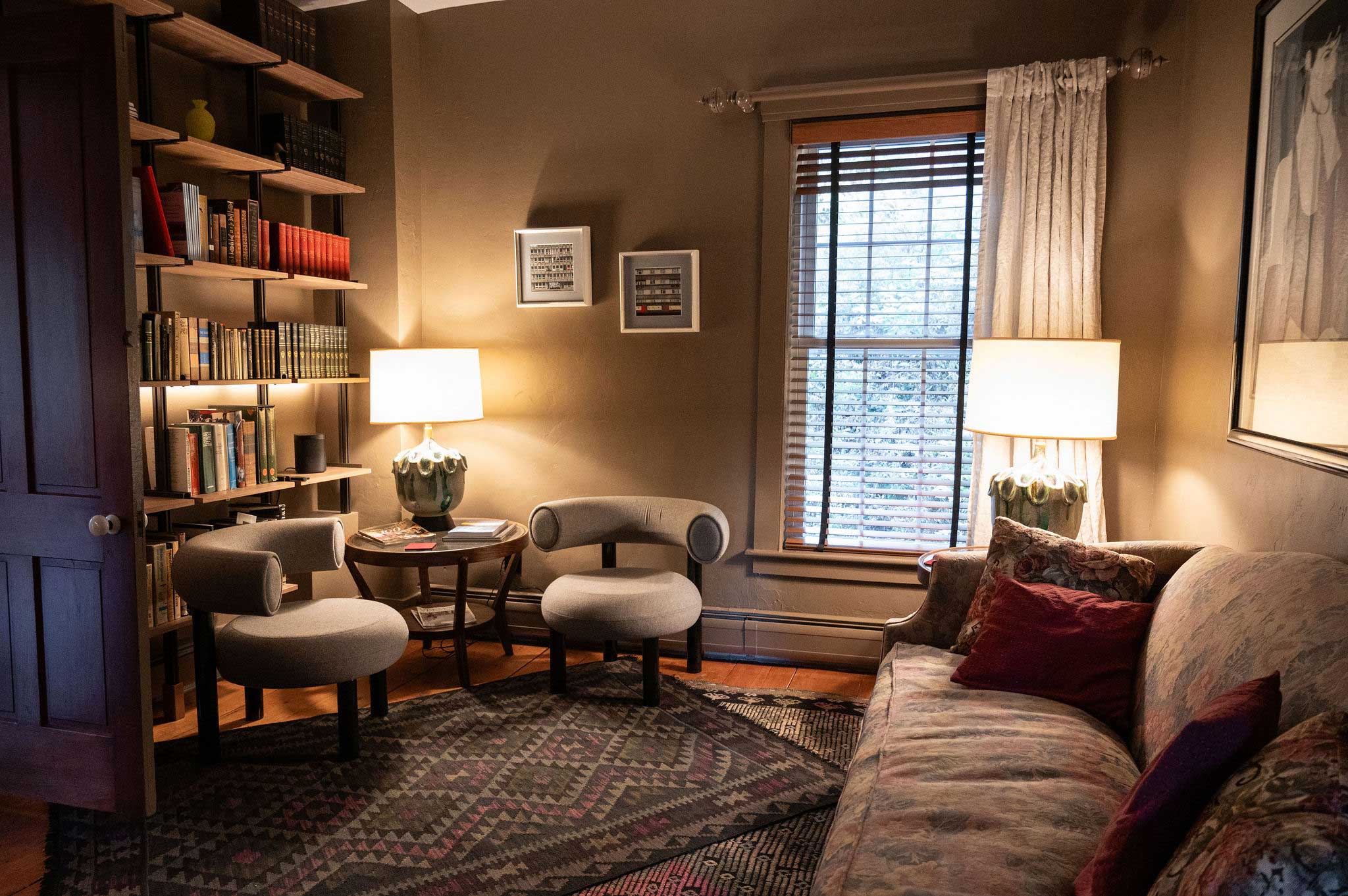 The reading room bookshelves and upholstered chairs