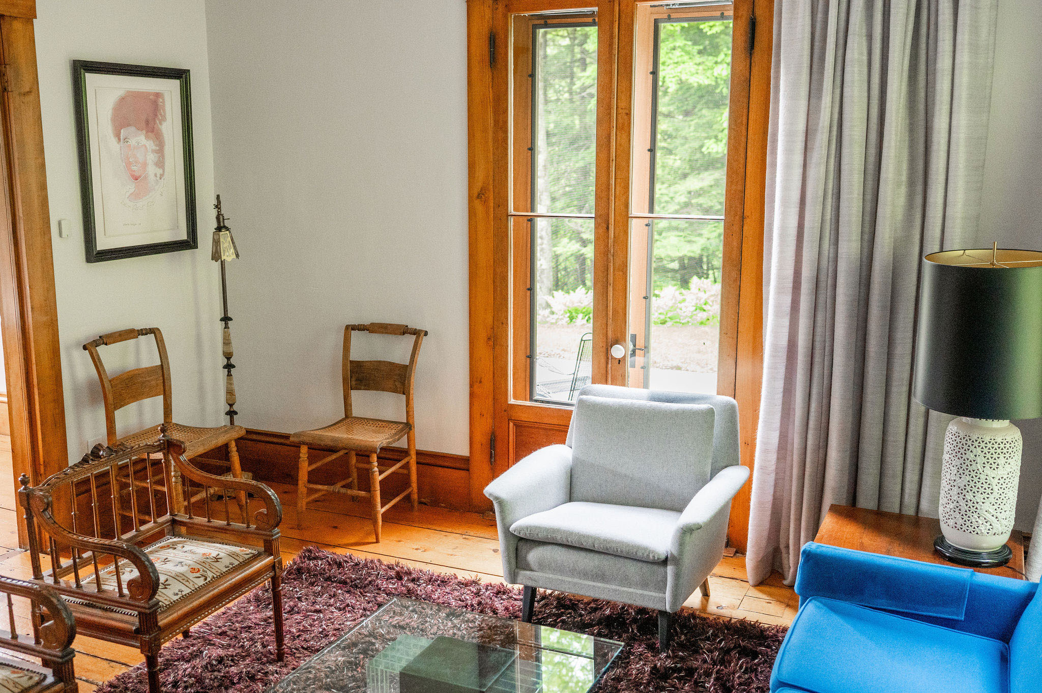 The Cobble House sitting room Looking down at a corner of the sitting room with a large window and two chairs tucked into a corner