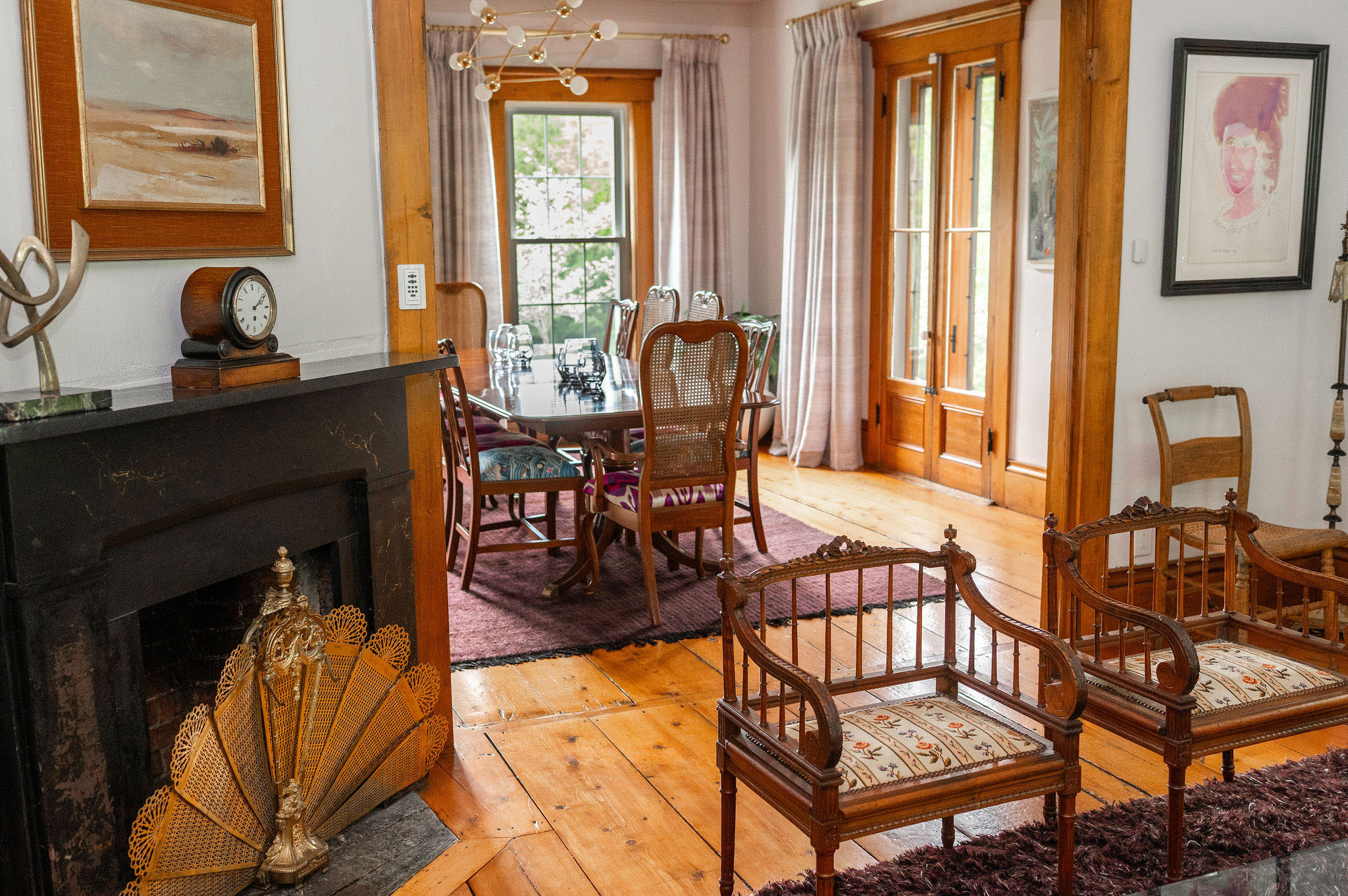 The Cobble House dining room seen from the parlor view from the parlor into the dining room, looking across two armchairs through the doorway