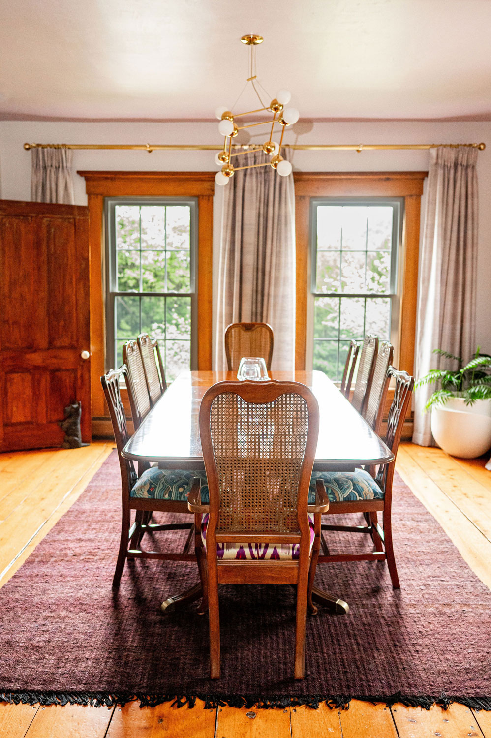 The Cobble House dining room Looking down the length of the dining room table at two large French doors leading out to the terrace
