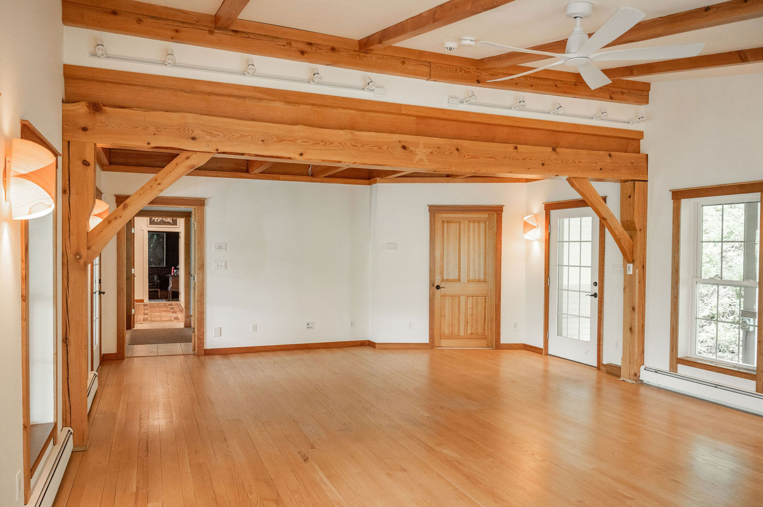 The Cobble House music room Looking down the spacious music room with gleaming wood floors and a beamed ceiling