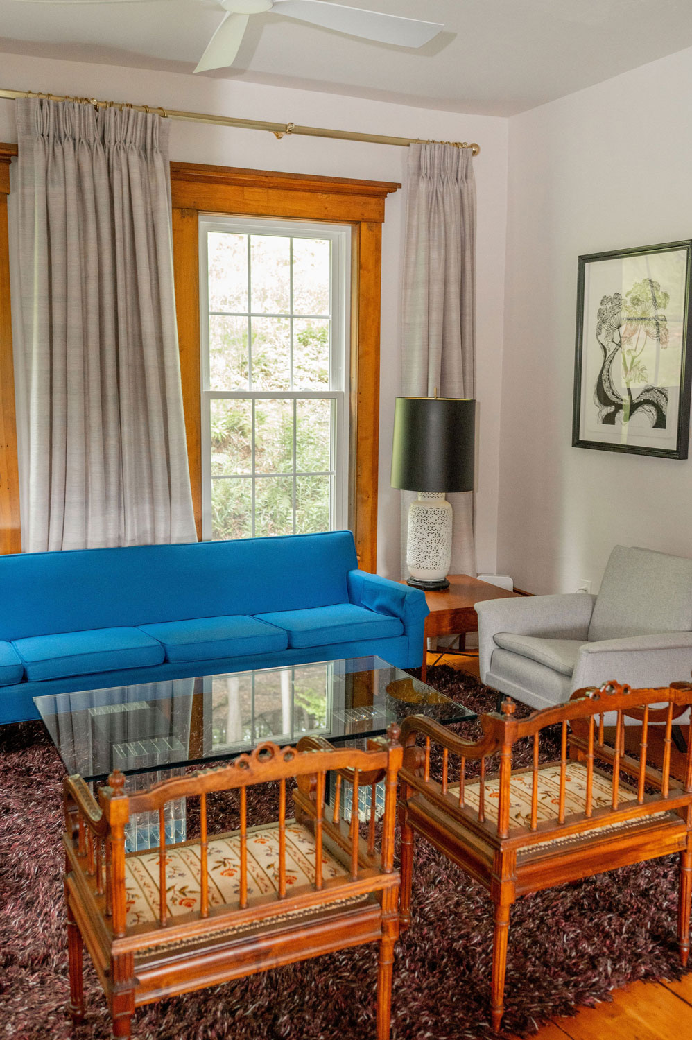 The Cobble House sitting room The sitting room with a blue couch against a window and faced by two armchairs