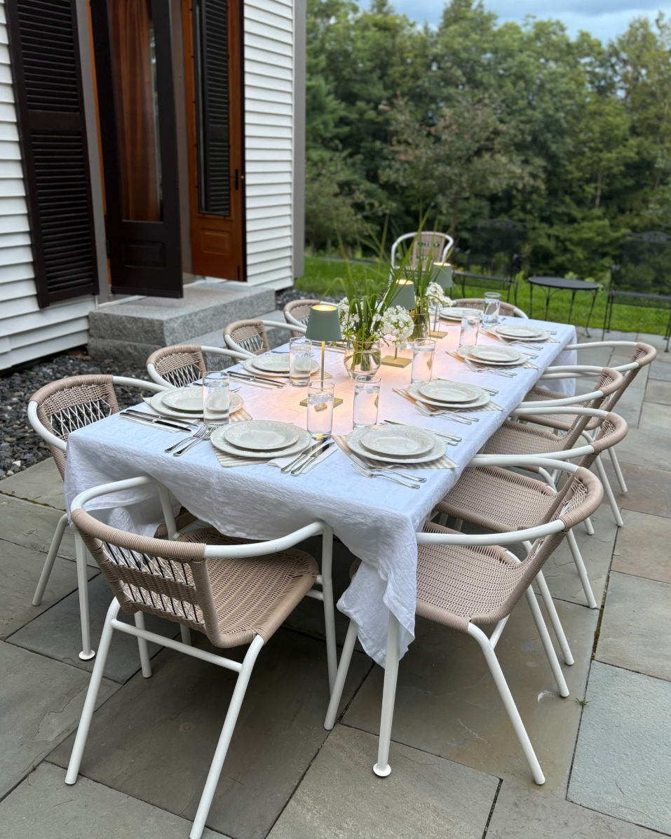 The Cobble House terrace with a table set for dinner on the bluestone terrace.